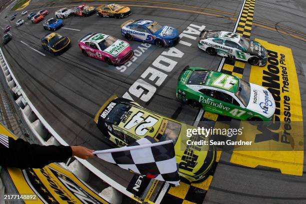 Ricky Stenhouse Jr., driver of the Kroger Health/Palmolive Chevrolet, takes the checkered flag ahead of Brad Keselowski, driver of the...