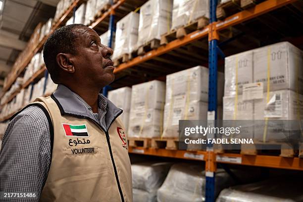 An Emirates Red Crescent volunteer checks humanitarian aid destined for Lebanon at the International Humanitarian City in Dubai, on october 11, 2024....