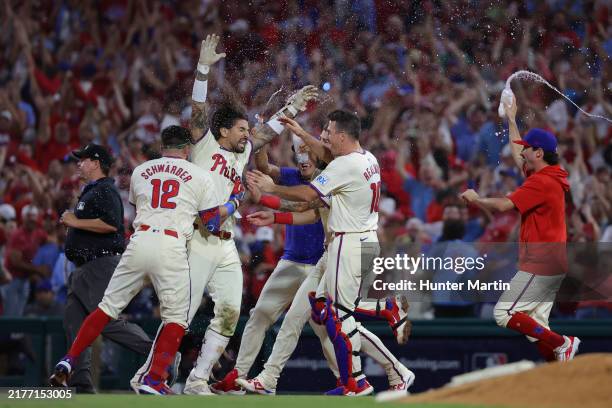 Nick Castellanos of the Philadelphia Phillies celebrates with teammates after the game-winning hit to defeat the New York Mets in Game Two of the...