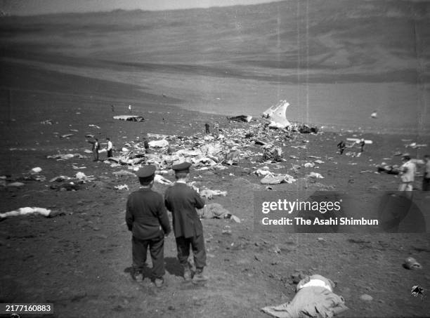 Police investigate as Japan Air Lines 301 Mokusei crash at Mt. Mihara previous day at Izu Oshima Island on April 10, 1952 in Senzu, Tokyo, Japan. All...
