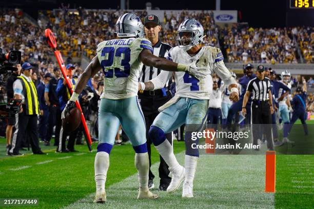 Rico Dowdle of the Dallas Cowboys celebrates a touchdown with Dak Prescott during the fourth quarter against the Pittsburgh Steelers at Acrisure...