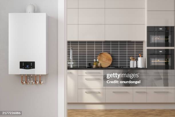 close-up of boiler with blurred kitchen background - bollitore foto e immagini stock