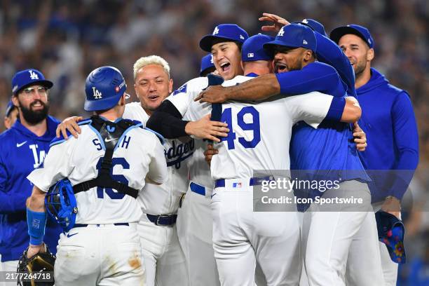 Los Angeles Dodgers designated hitter Shohei Ohtani celebrates with Los Angeles Dodgers outfielder Teoscar Hernandez and Los Angeles Dodgers pitcher...