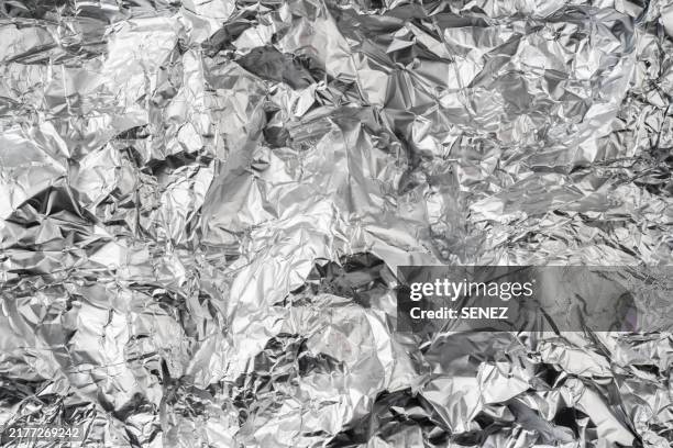 aluminum foil texture close up,full frame shot of abstract background - folie stockfoto's en -beelden