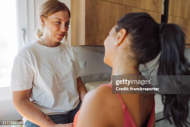 passionate couple embracing at home - lesbians flirting stock pictures, royalty-free photos & images