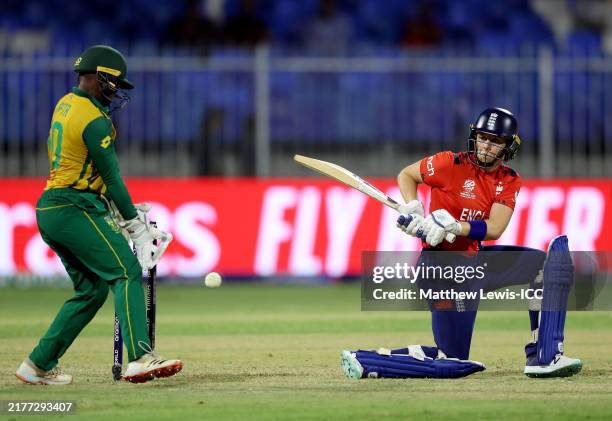 Heather Knight of England bats as Wicketkeeper Sinalo Jafta of South Africa looks on during the ICC Women's T20 World Cup 2024 match between England...