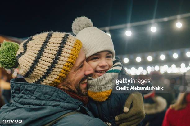 father and son at the christmas market - holiday spirit stock pictures, royalty-free photos & images