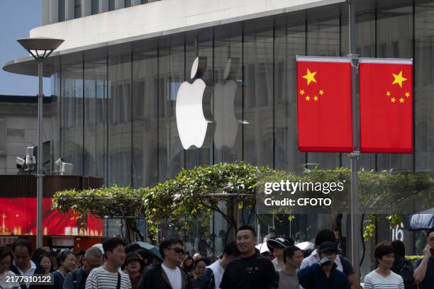 Visitors pass the Apple Store on Nanjing Road Pedestrian Street in Shanghai, China, October 12, 2024.