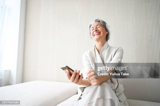 amazed woman with mobile phone. - tears of joy stock pictures, royalty-free photos & images