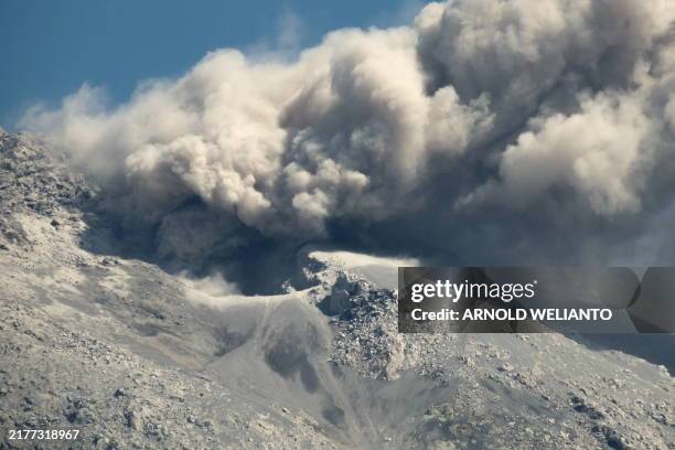 Mount Lewotobi spews volcanic ash from its crater during an eruption as seen from Duripali village in East Flores, Indonesia's East Nusa Tenggara...