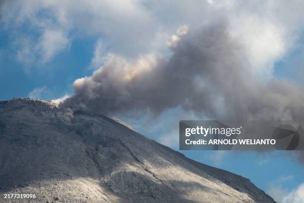 Mount Lewotobi spews volcanic ash from its crater during an eruption as seen from Duripali village in East Flores, Indonesia's East Nusa Tenggara...