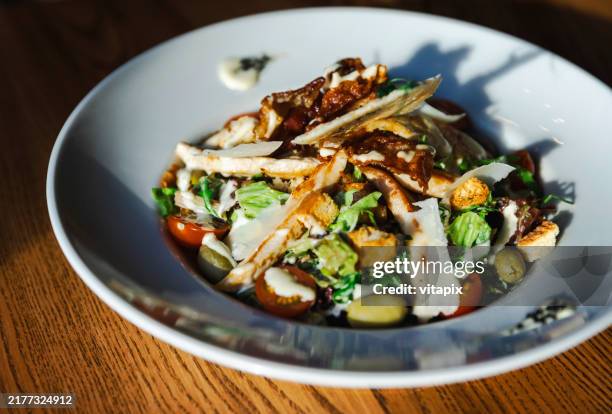 delicious fresh chicken caesar salad with croutons and parmesan - condiment stock pictures, royalty-free photos & images