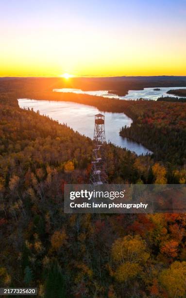 fall colors with a firetower and lake - lake superior stock pictures, royalty-free photos & images