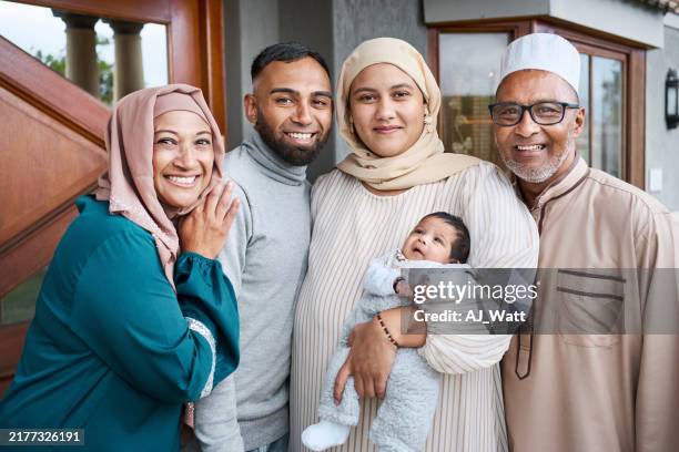 parents and their baby girl smiling with their family outside of their home - muslim husband wife stock pictures, royalty-free photos & images