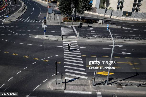 Person walks on a crosswalk on an empty street on Yom Kippur, the Jewish day of atonement and the holiest day in the Jewish calendar, amid the...
