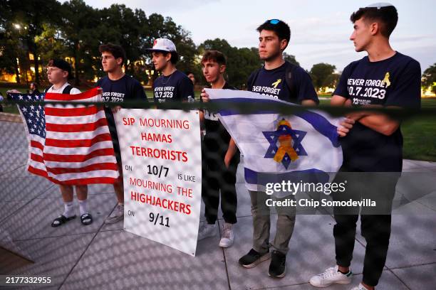 Counter demonstrators stand outside a temporary security barrier during a vigil organized by the Students for Justice in Palestine along McKeldin...