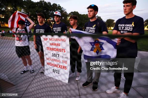 Counter demonstrators stand outside a temporary security barrier during a vigil organized by the Students for Justice in Palestine along McKeldin...