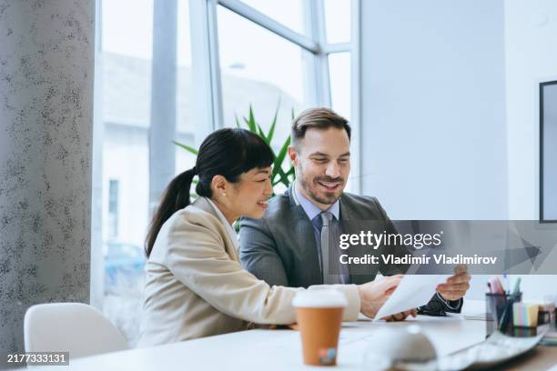 business professionals reviewing a document - financial services stock pictures, royalty-free photos & images