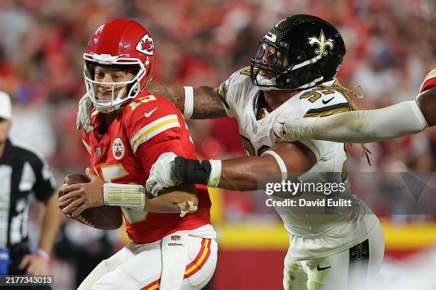 Chase Young of the New Orleans Saints sacks Patrick Mahomes of the Kansas City Chiefs during the second quarter at GEHA Field at Arrowhead Stadium on...