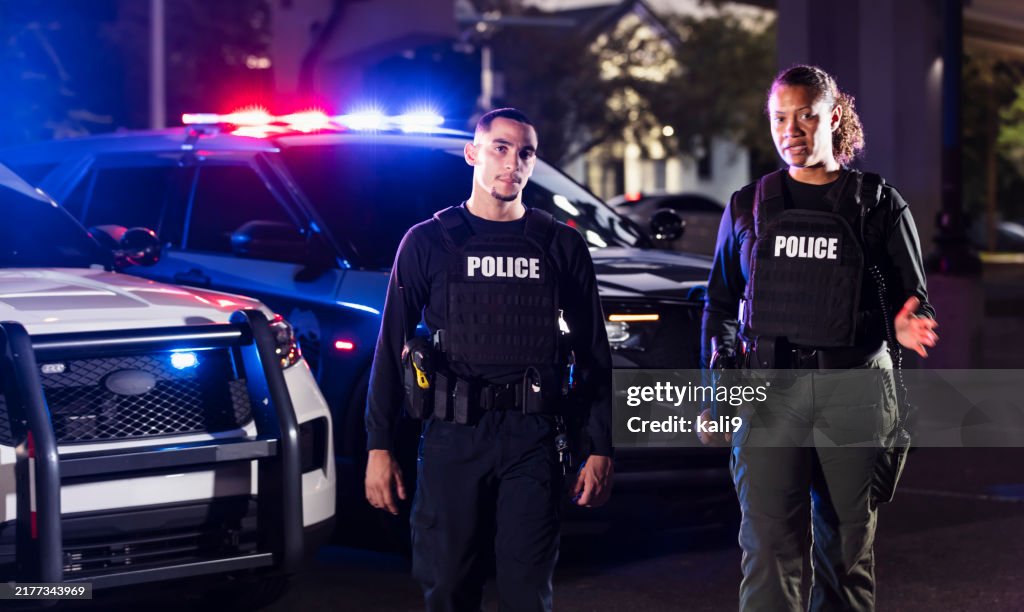 Police Activity Outside Two Multiracial Police Officers Working Outdoors At Night High-Res ...