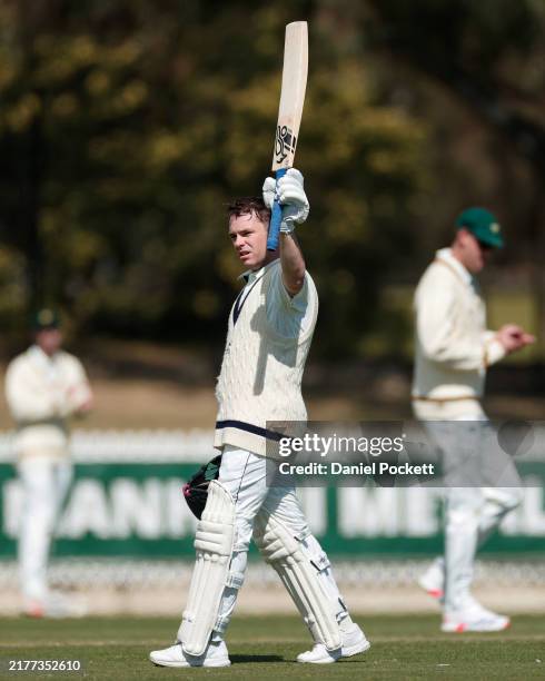 Marcus Harris of Victoria raises his bat after making a century during the Sheffield Shield match between Victoria and Tasmania at CitiPower Centre,...
