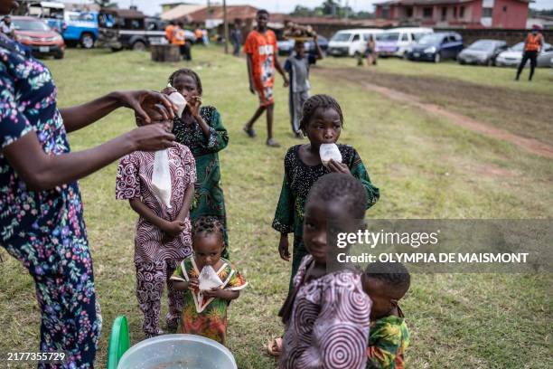 Children get refreshments as they attend the Igboora World Twins Festival 2024, in Igbo-Ora on October 12, 2024. Nigeria's self-proclaimed 'twins...