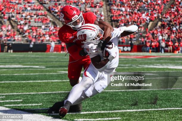 Darrion Dupree of the Wisconsin Badgers is tackled by Moses Walker of the Rutgers Scarlet Knights during the first half at SHI Stadium on October 12,...