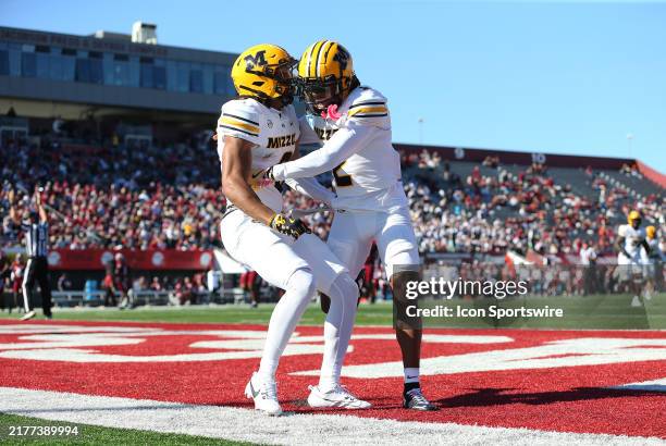 Missouri Tigers wide receiver Joshua Manning scores a touchdown and celebrates with Missouri Tigers wide receiver Marquis Johnson during a college...