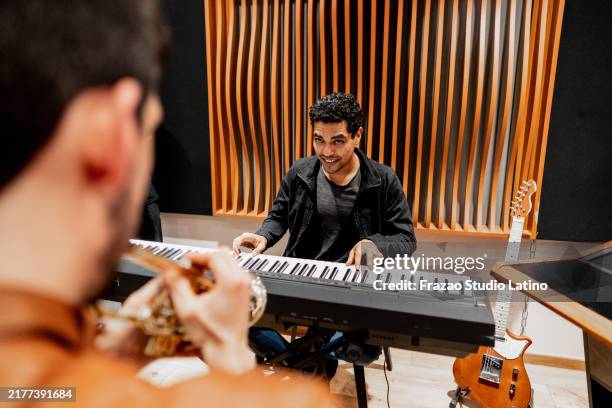 young man playing synthesizer at music studio - synthesizer stock pictures, royalty-free photos & images