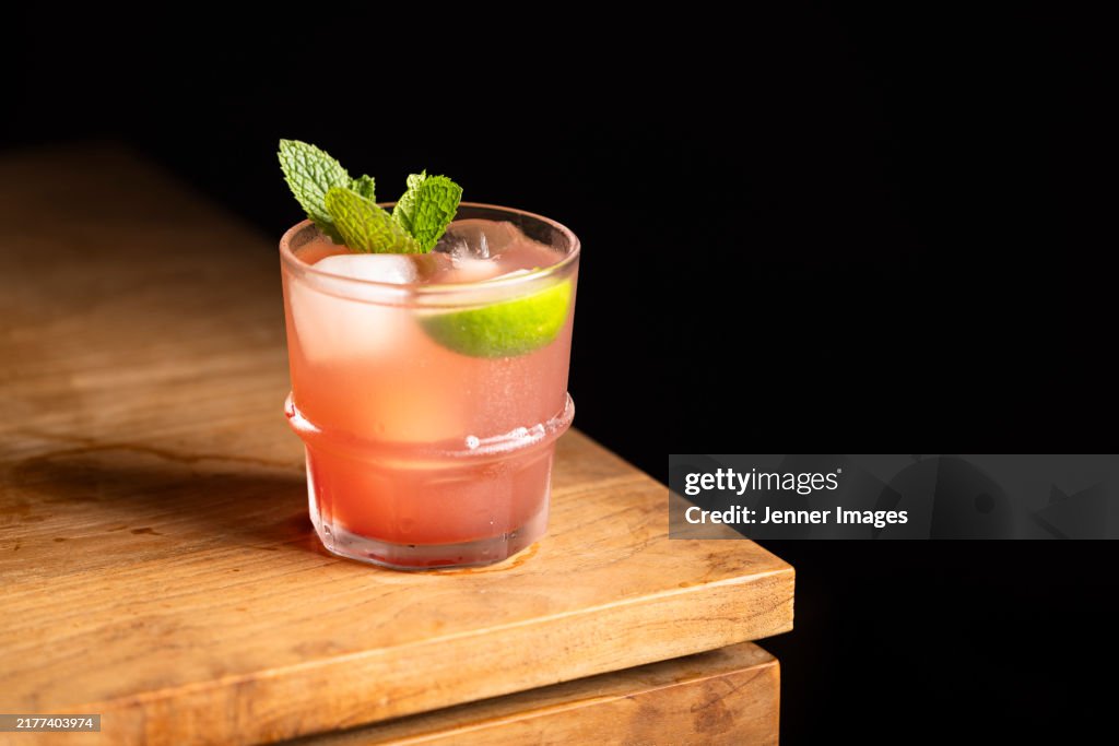 Non alcoholic Pineapple and Cranberry Mocktail. Garnished with Lime and mint leaves.
