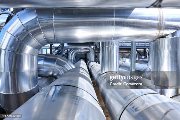 crowded silver colored pipelines - chemical plant stock pictures, royalty-free photos & images