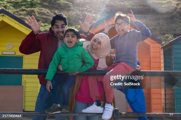 family making silly faces at the beach - religious veil stock pictures, royalty-free photos & images