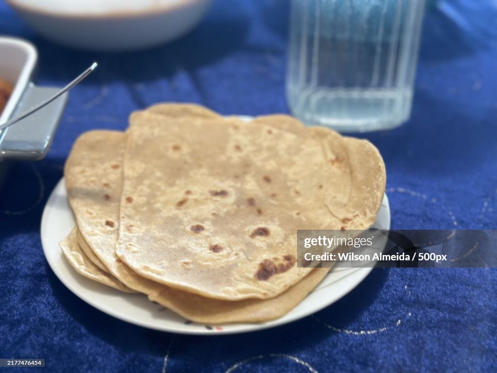 Close-up of chapati bread and drink on table,Denmark
