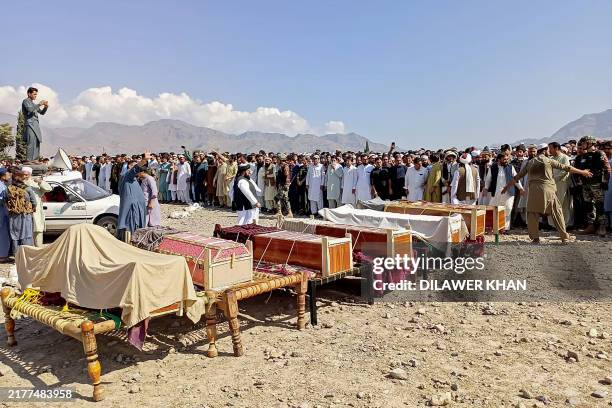 Sunni Muslim men gather to offer prayers during the funeral ceremony for victims who were killed in a tribal clash, at Kurram district in Khyber...
