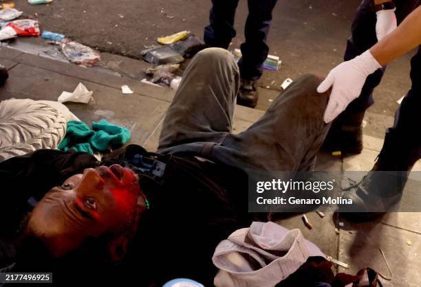 Man is revived by Emergency medical technicians and paramedics with Los Angeles Fire Station 11 after an overdose at the corner of S. Alvarado and...