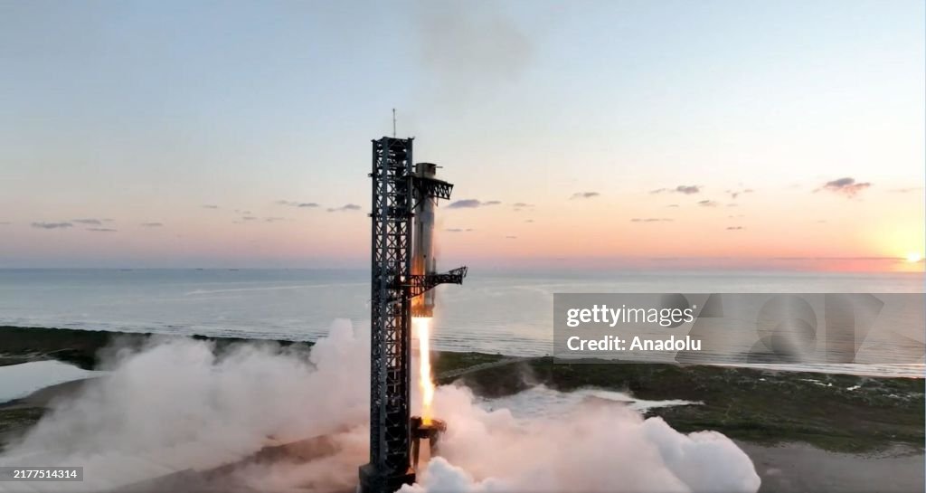 Starship's Super Heavy rocket booster is caught mid-air during the fifth flight test in Texas