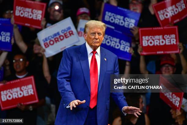 Former US President and Republican presidential candidate Donald Trump dances during a campaign rally at Findlay Toyota Arena in Prescott Valley,...