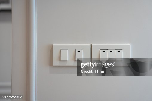 Modern light switch panel on white wall Modern light switch panel on white wall
