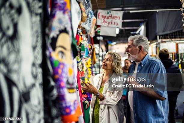 senior couple shopping on local market - gift shop stock pictures, royalty-free photos & images