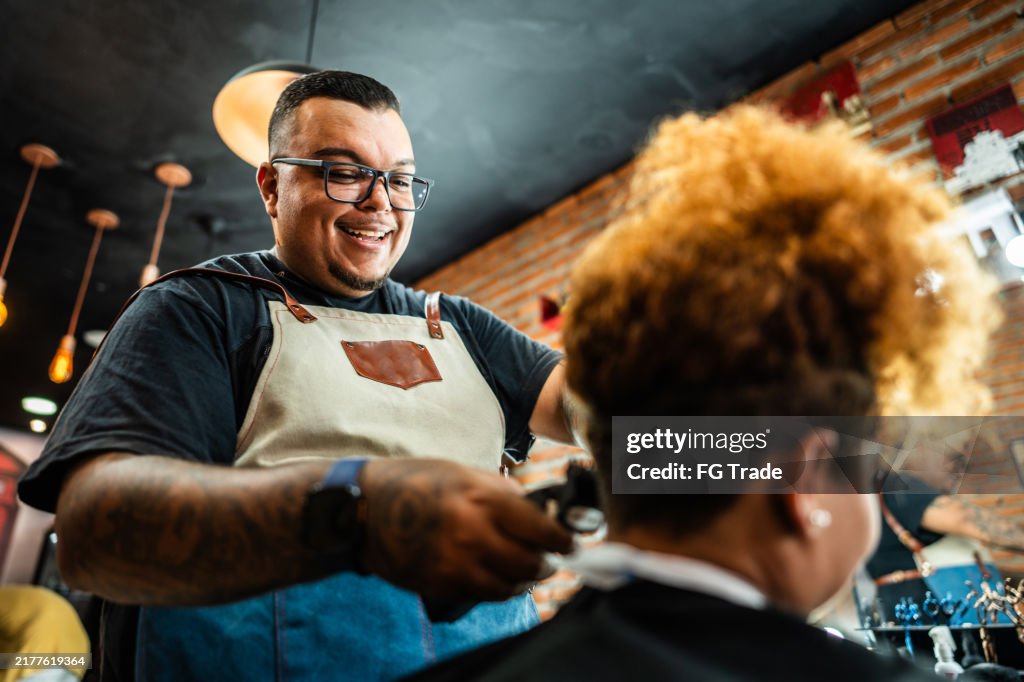 Barber cutting the customer's hair at a barber shop