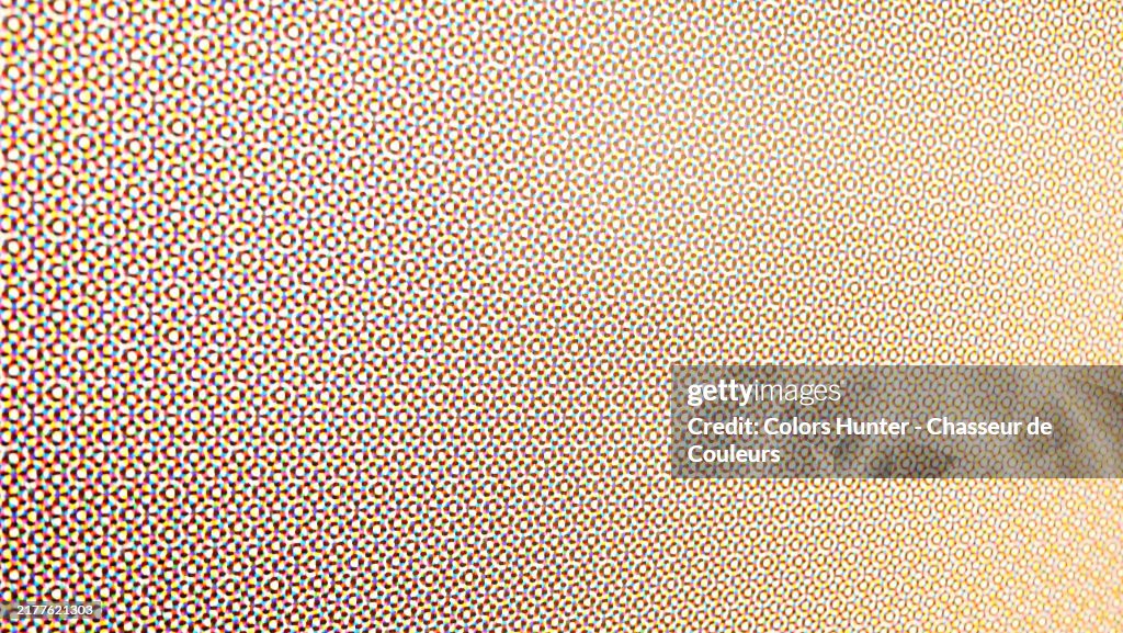 Colorful and blurred dots on a white background. Macro and overexposed photograph of an offset printed poster. Side view (focus on the left foreground). Sunlight. Natural colors. Paris, France.