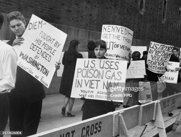 Protestors holding placards during an anti-war demonstration, United States, circa 1962. The placards read 'Diem - Fought by His People, Defended by...