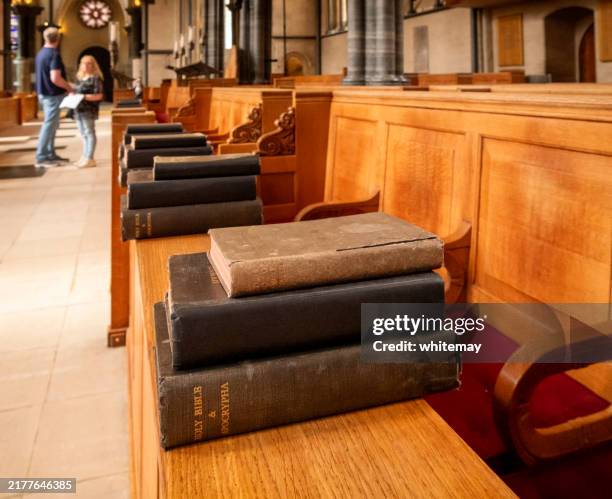 bibles, prayer books and hymnals inside temple church - holy book stock pictures, royalty-free photos & images
