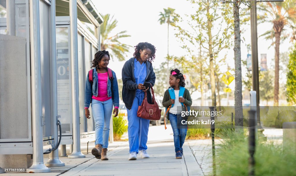 African-American working mother takes daughters to school
