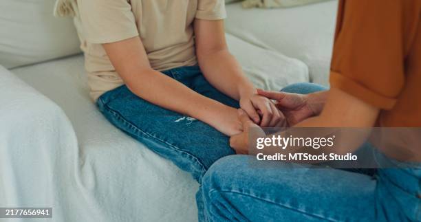 young mother is scolding her son at home, addressing his misbehavior with a serious expression in domestic. family moment concept. - slapping stock pictures, royalty-free photos & images