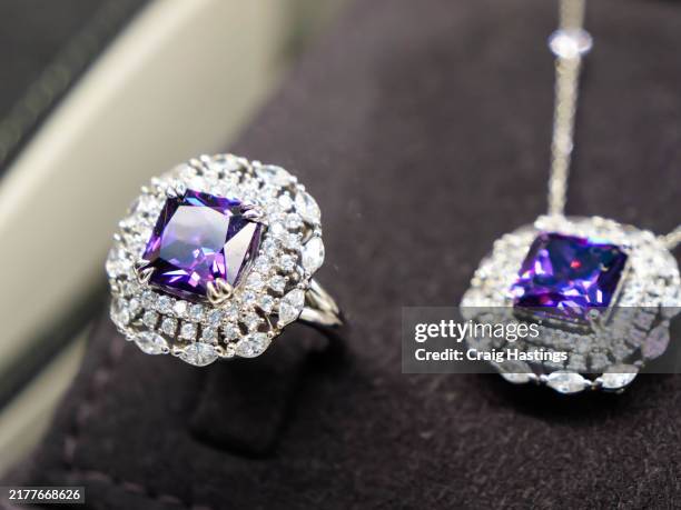dubai souk - macro close up purple amethyst coloured gemstone set rings arranged in a row in jewellery store shop setting. luxury ring display with shining colourful stones and diamonds. high end luxury shopping - amethyst stock pictures, royalty-free photos & images