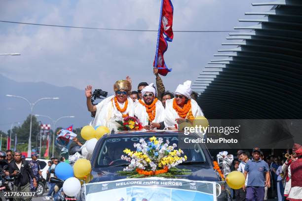 Record-setting climber Nirmal Purja, also known as Nimsdai, cheers as he arrives back in Kathmandu, Nepal, on October 14 after completing the summit...