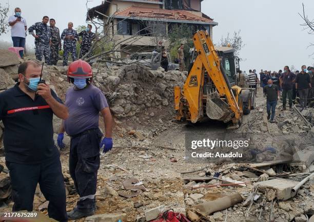 Lebanese emergency teams, soldiers and civilians conduct a search and rescue operations after Israeli airstrikes on village of Aitou in the...