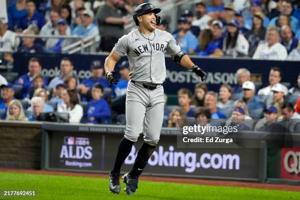Giancarlo Stanton of the New York Yankees celebrates after hitting a home run in the eighth inning against the Kansas City Royals during Game Three...
