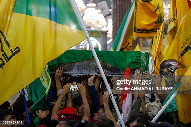 People carry the coffin of Iran's Islamic Revolutionary Guards Corps commander Abbas Nilforoushan during a funeral procession at the Imam Hussein...